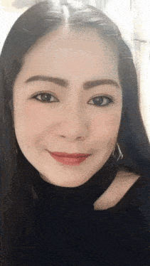 a close up of a woman 's face with a black shirt on