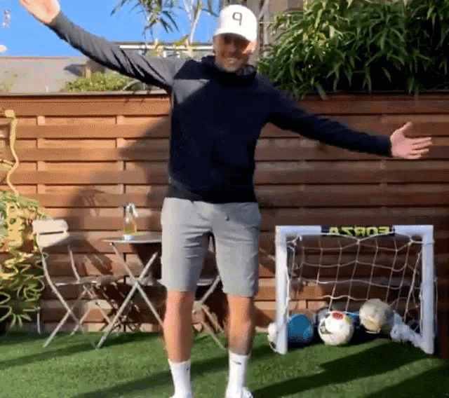 a man standing in front of a soccer goal that says astros