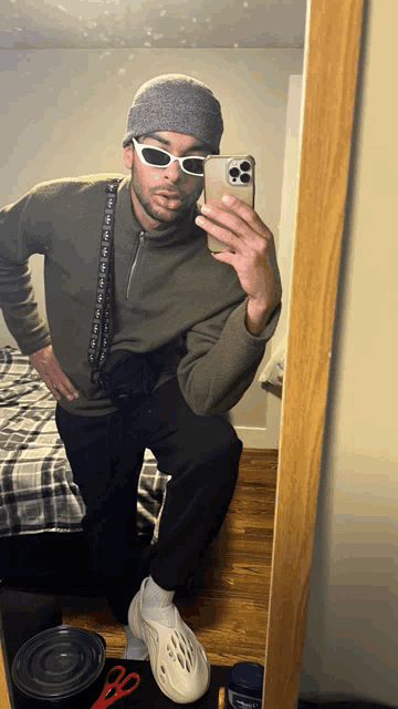 a man taking a picture of himself in the mirror