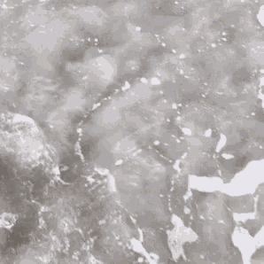 a close up of a body of water with waves crashing against the rocks .
