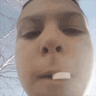 a person with a marshmallow in their mouth