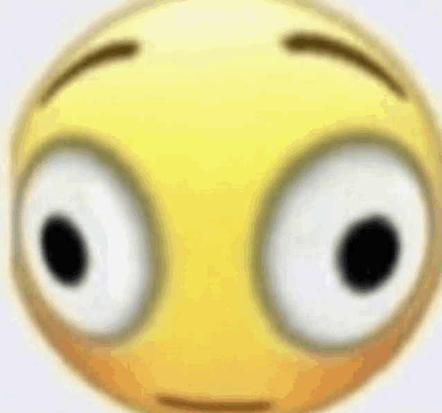 a close up of a smiley face with big eyes and a blurred background .