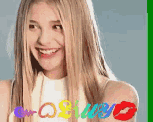 a woman with long blonde hair is smiling and holding a red kiss on her hand .