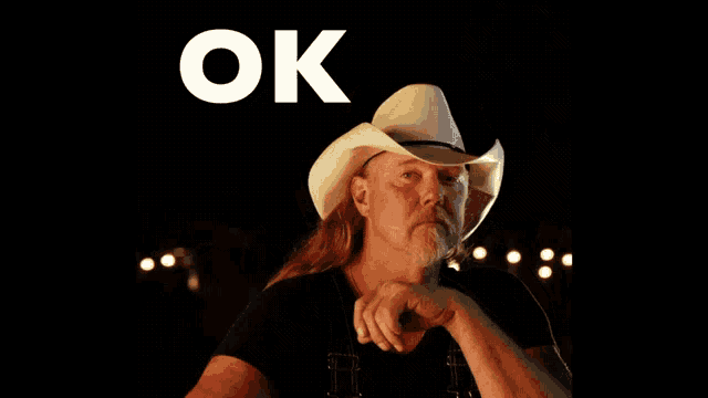 a man wearing a cowboy hat with the word ok written above him