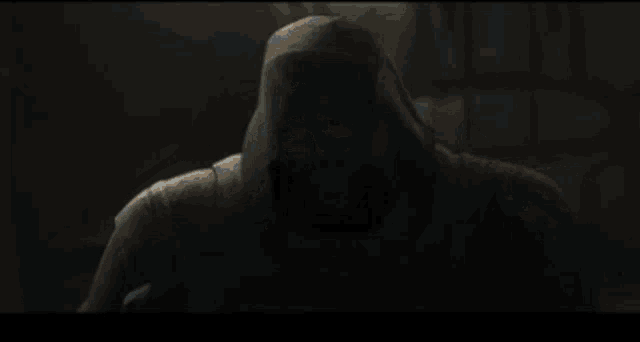 a bald man in a video game holds his head with his hands