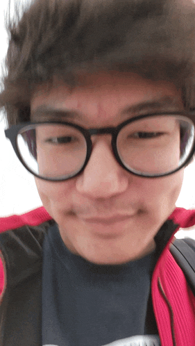 a close up of a man wearing glasses and a black shirt with the word columbia on it