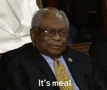 a man in a suit and tie is saying " it 's meal "