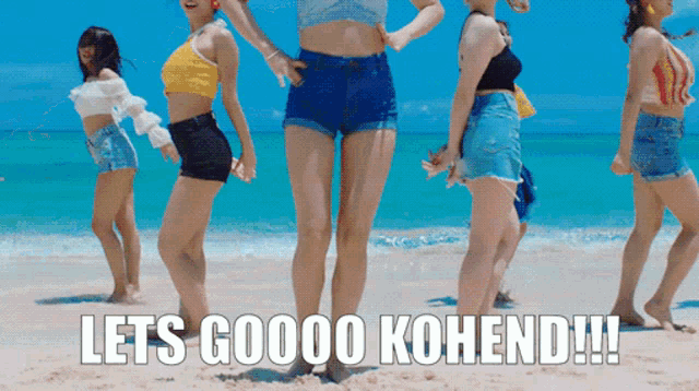 a group of women dancing on a beach with the words let 's goooo kohend