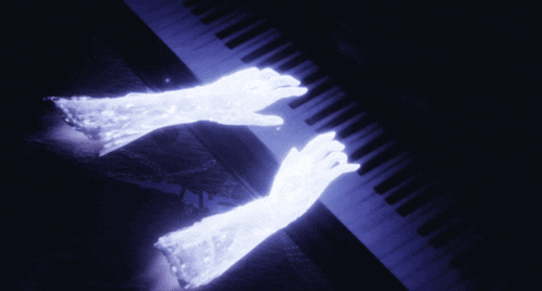 a pair of glowing hands playing a piano keyboard