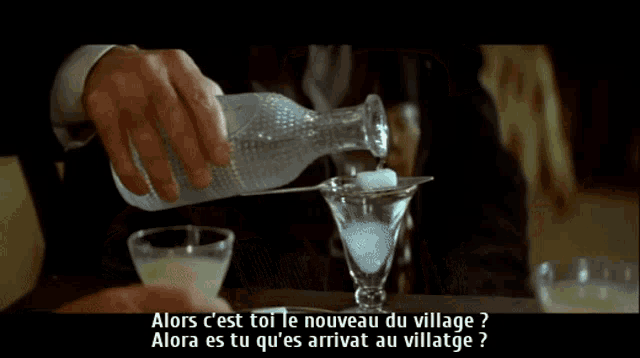 a man with a mustache is talking in french
