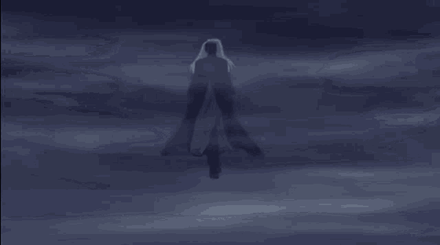 a man is standing in front of a full moon in a dark sky .