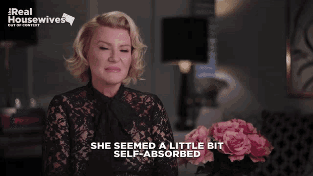 a woman says she seemed a little bit self absorbed in front of flowers