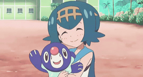 a girl is holding a stuffed animal in her arms and smiling .