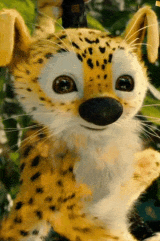 a close up of a stuffed cheetah with big eyes