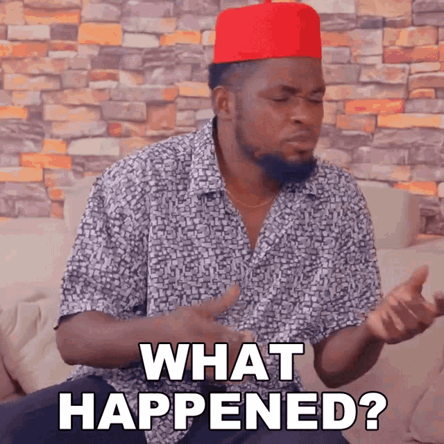 a man wearing a red hat is sitting on a couch and asking what happened