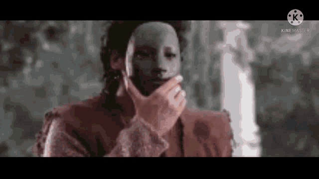 a man with a mask on his face is covering his mouth .