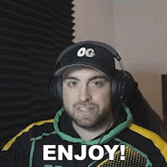 a man wearing headphones and a hat with the word enjoy on it