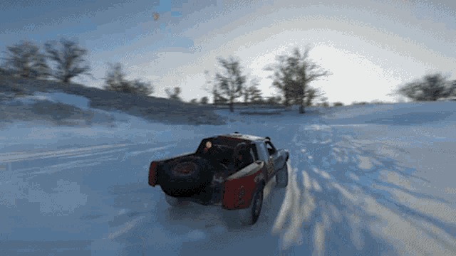 a truck is driving through a snowy field with a tire that says bfgoodrich on the back