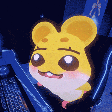 a yellow hamster is sitting in front of a keyboard