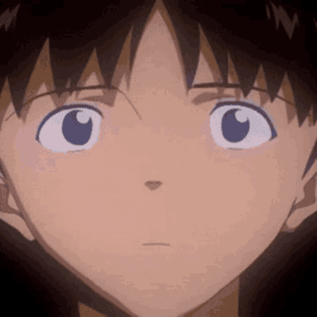 a close up of a person 's face with a serious look on their face .