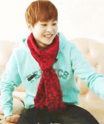 a person wearing a scarf around their neck and a sweatshirt that says cs on it