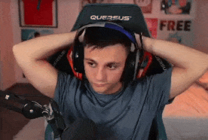 a young man is wearing headphones while sitting in a chair .