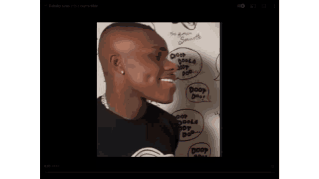 a man is smiling in front of a wall with speech bubbles that say doop doop doop
