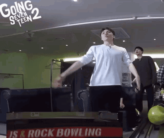 a man is dancing in front of a sign that says going seventeen 2 is a rock bowling