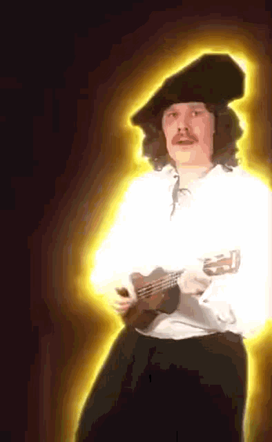 a man with a mustache is holding a guitar and wearing a black hat