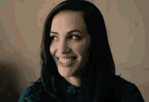 a close up of a woman 's face smiling