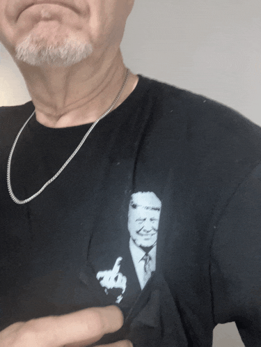 a man wearing a black shirt with a picture of a man giving a middle finger