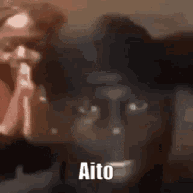 a blurry picture of a person with the word aito on the bottom right