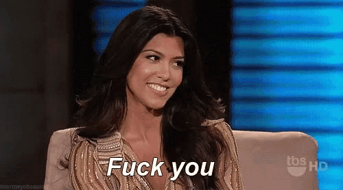 a woman is sitting in a chair with the words `` fuck you '' written on the screen .