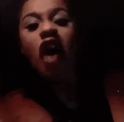 a close up of a person 's face with their mouth wide open