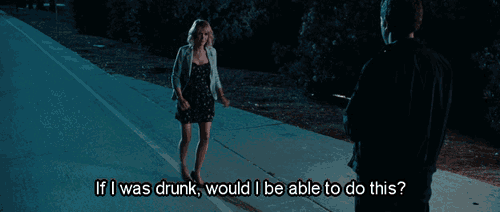 a woman in a dress is walking down a sidewalk with the words if i was drunk would i be able