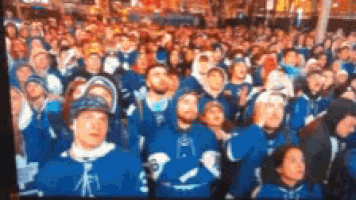 a large crowd of people wearing blue and white jerseys with the number 8 on them