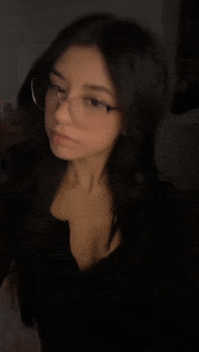 a blurry picture of a woman wearing glasses .