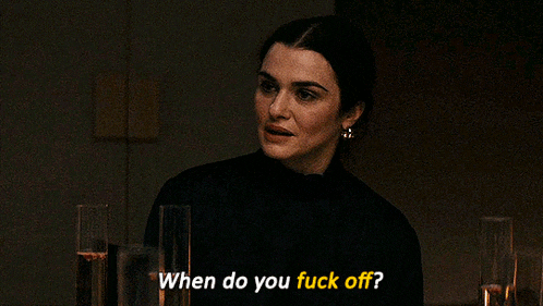 a woman is sitting at a table with glasses of champagne and says when do you fuck off