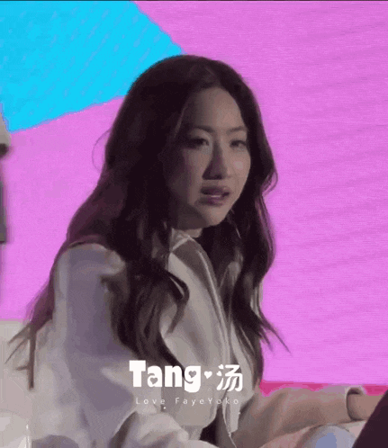 a close up of a woman 's face with the word tang on it .