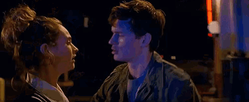 a man and a woman are looking into each other 's eyes .
