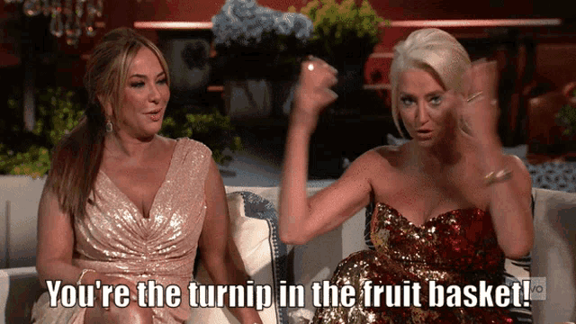 two women sitting on a couch with the words " you 're the turnip in the fruit basket "