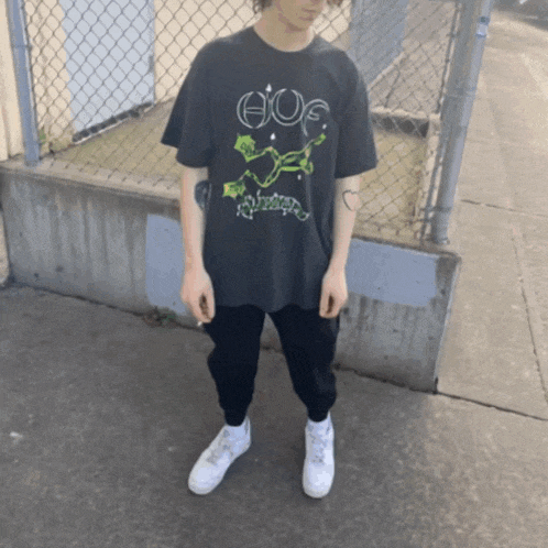 a person wearing a black shirt that says huf