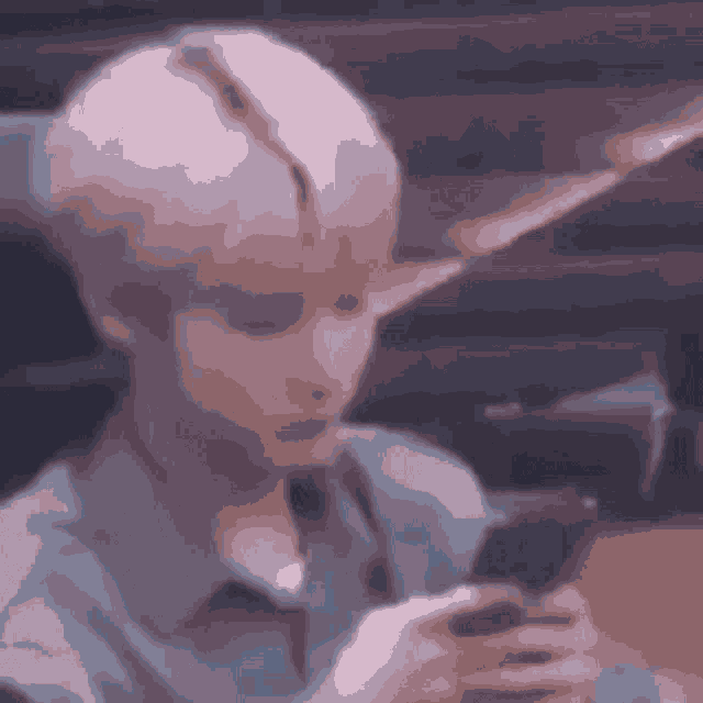 a young man is holding a cell phone in his hand .