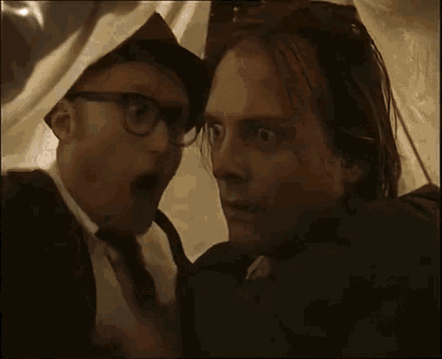 two men are looking at each other and one of them is pointing at the word wobbles