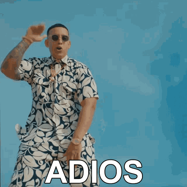a man in a hawaiian shirt is dancing with the word adios behind him