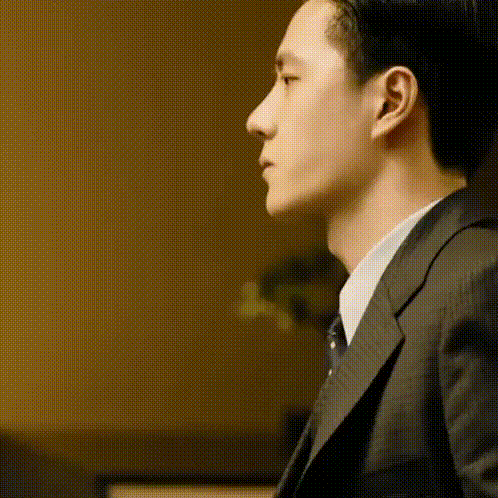 a close up of a man in a suit and tie .