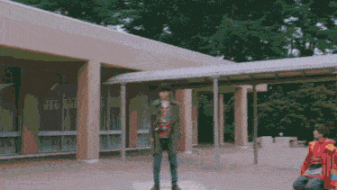 a man standing in front of a building with a sign on it that says ' a ' on it