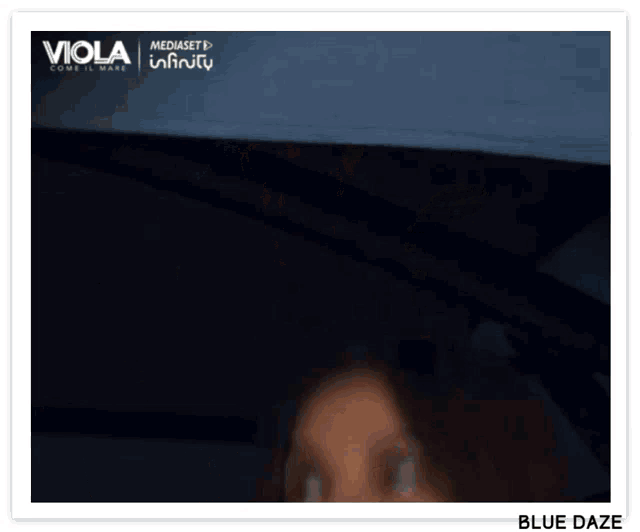 a blurred image of a woman with viola and mediaset infinity written on the bottom