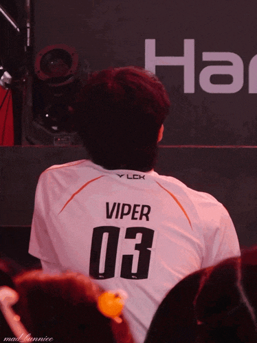 a man wearing a white jersey with viper 03 on the back
