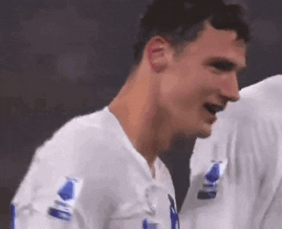 a soccer player wearing a white shirt with the number 1 on the sleeve